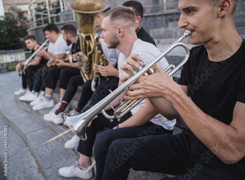 Young street music band play a lot of musical instruments