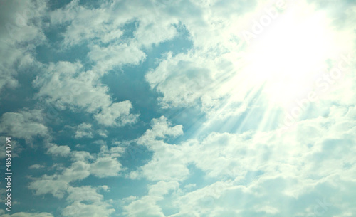Nature background of light blue sky and white clouds with a beautiful sunshine and sun rays glowing