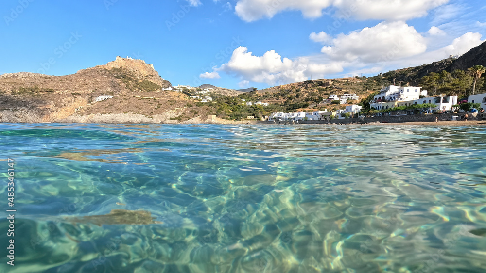 Underwater split photo taken from beautiful emerald bay and beach of Kapsali overlooking famous castle of Kythira island, Ionian, Greece