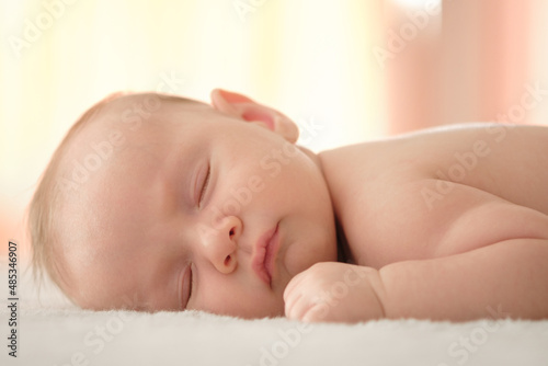 Closeup portrait of a cute infant baby sleeping. Beautiful white small baby sleeping at home. Portrait of a tiny caucasian boy resting. Face of a napping child, during an afternoon nap. Kid relaxing.