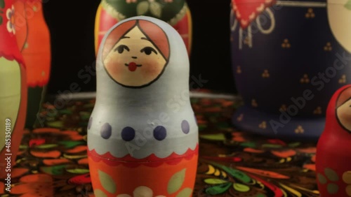 Figures of popular Russian nesting dolls on a Zhostovsky dish. Family. Circular panorama. photo