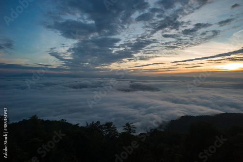 Sunrise cloud sky with morning fog over the mountain