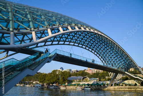 The Tbilisi Peace Bridge at day with blue sky in Tiblisi, Georgia