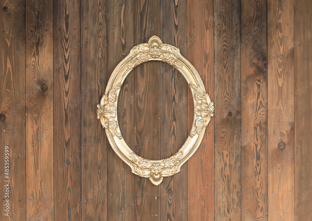artistic gold frame on wooden wall artistic gold frame on wooden wall