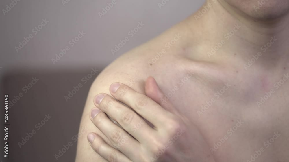 Man with pain in shoulder at home, health problems concept Man with pain in shoulder at home, health problems concept