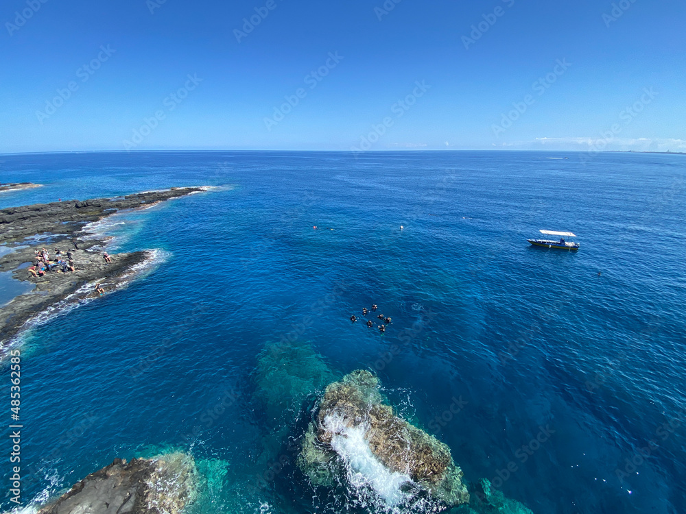 People waiting to start scuba diving in beautiful blue water of Reunion island