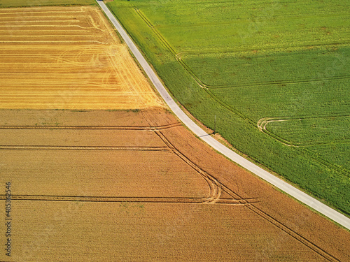 Aerial drone view of green and yellow fields in Normandy, France
