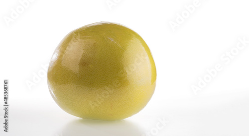 The ripe fruit is pomelo in the PE package for storage and transportation isolated on a white background. photo