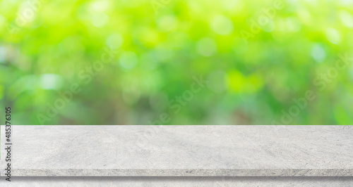abstract blurred garden view form living room window with concrete table counter background for show , promote ,design banner ads on display concept