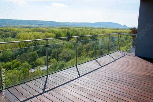 Fotografie Apartment balcony scenery view with exotic grooved cumaru wood decking and moder