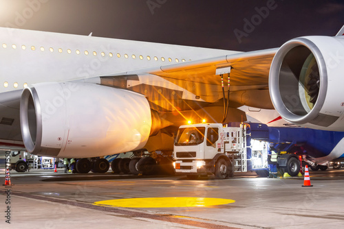 Принти на полотні Process of aircraft jet airplane refueling by high pressure fuel supply truck at night
