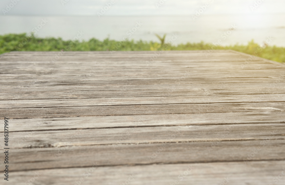 Φωτογραφία Panoramic empty clean wood counter table top blur shinny white bokeh light on summer beach background for product morning scene display montage, Abstract Blurry wooden desk in vacation trip backdrop