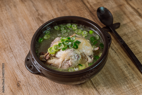 Samgyetang, Korean Ginseng Chicken Soup : Tender, whole, young chicken stuffed with ginseng, jujubes, sweet rice, and whole garlic cloves and simmered until tender. The combination of chicken and gins photo