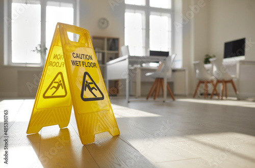 Konstfotografi Close up of yellow standing plastic sign with human figure that slips and falls
