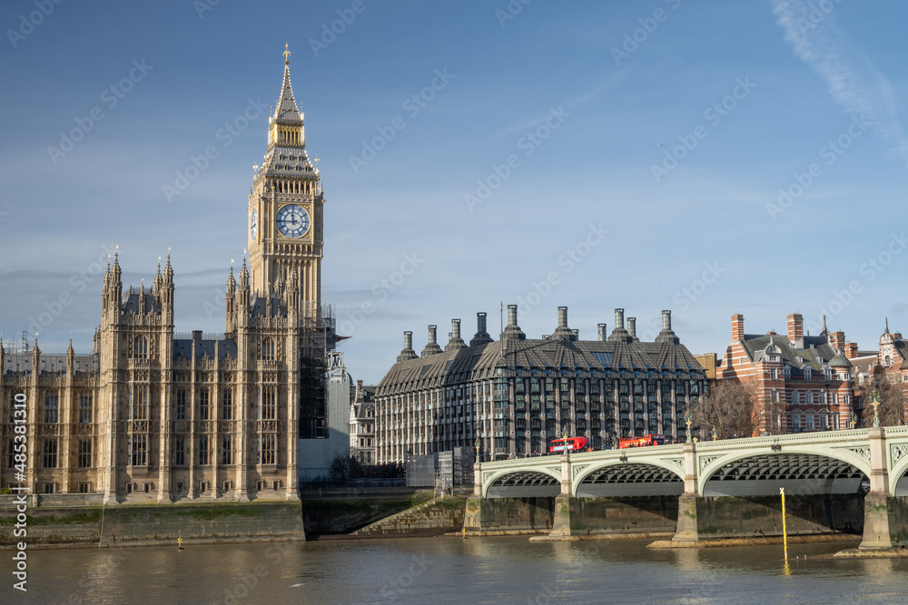 View of restored 2022 iconic Big Ben clock tower and Westminster palace in front of Thames River