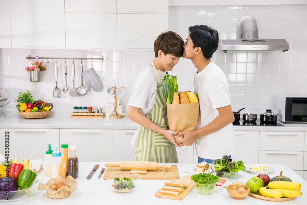 gay man kiss his partner in kitchen