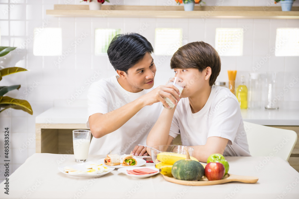 gay man feed milk to his partner during breakfast