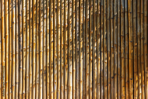 Fototapeta Naklejka Na Ścianę i Meble -  Yellow bamboo wall with natural light shade
