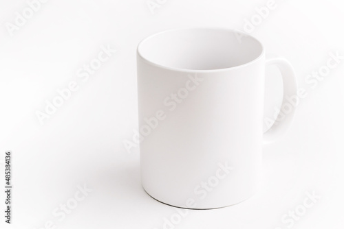 White ceramic cup on white background.