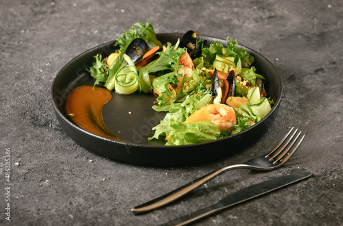 Healthy salad plate. Fresh seafood recipe. fresh vegetable salad.with mussels. Grilled prawns. Healthy food.