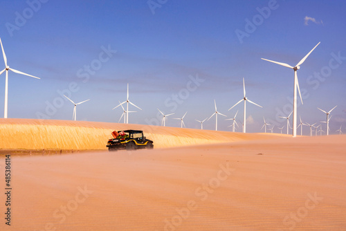 Wind turbines in the dessert with sand buggy