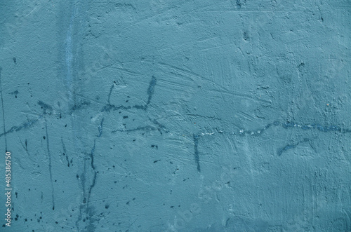 Abstract background of old blue-green paint on the wall.