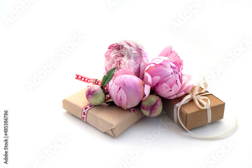 gift boxes, a bouquet of beautiful pink peonies on a white background. congratulations on Valentine's Day, mother's day, birthday