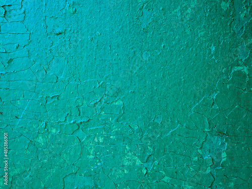 Damaged weathered green background, old with paint worn metal wall surface texture.