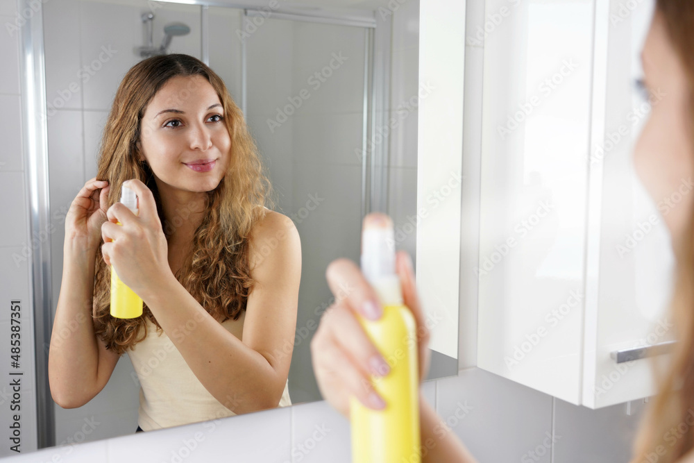 Hair lightening spray. Smiling girl applying hair lightening spray for  dyeing hair. Haircare cosmetic. Stock-Foto | Adobe Stock