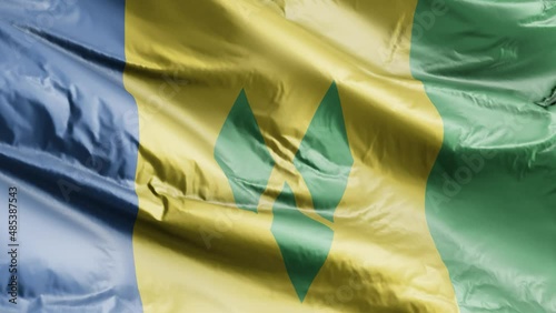 Saint Vincent and the Grenadines flag waving on the wind loop. Saint Vincent and the Grenadines banner swaying on the breeze. Full filling background. 10 seconds loop. photo