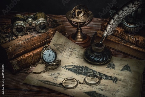 steampunk atmosphere, desk with submarine map with old accessories to create the office of Jules Verne