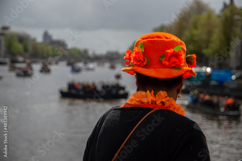 Woman Looking At Amstel River During Kingsday At Amsterdam The Netherlands 27-4-2019