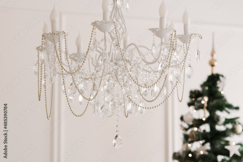 Large crystal glass chandelier with gold inserts in the living room