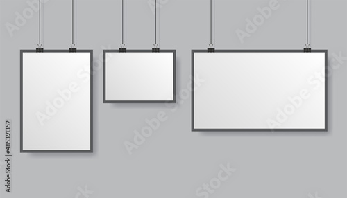 Vector poster mockup with white frame isolated on grey background with soft shadow. Realistic empty grey posters template ready for your design. Binder keeps placard.