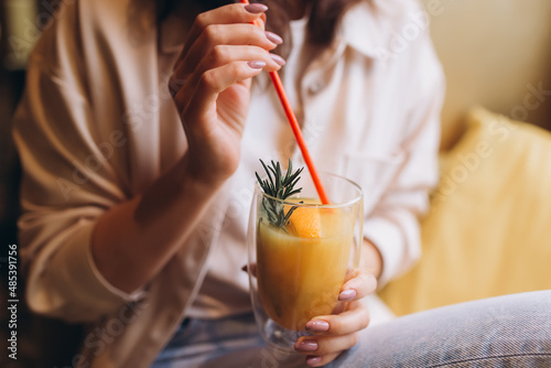 Brunette woman in cafe drink vitamin fresh