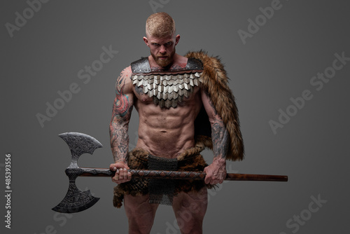 Dangerous nordic vandal with naked torso and steel axe