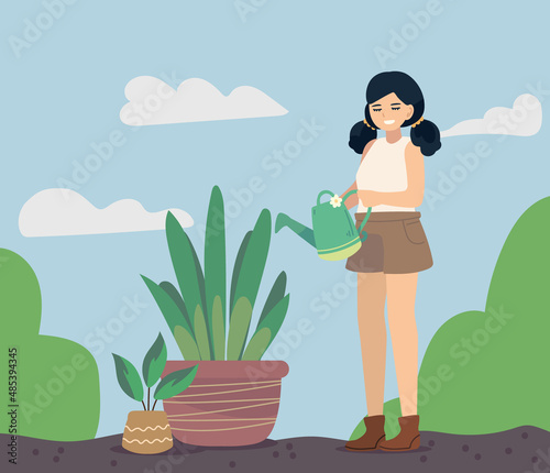 woman pouring water in plant
