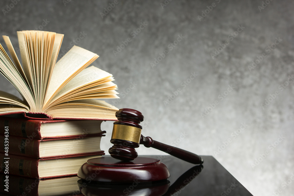 Legal Law and Justice concept - Open law book with a wooden judges gavel on table in a courtroom or law enforcement office. Copy space for text. Legal Law and Justice concept - Open law book with a wooden judges gavel on table in a courtroom or law enforcement office. Copy space for text.