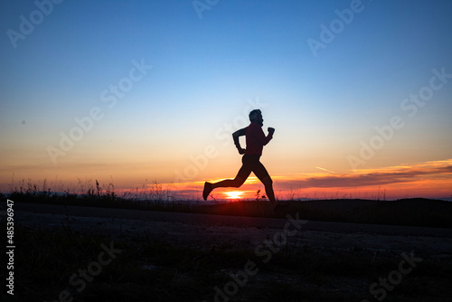 Fototapeta Naklejka Na Ścianę i Meble -  active man silhouette running at sunset