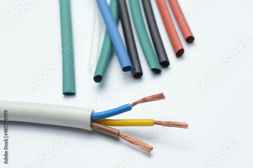 heat shrink tubing and a three-core stripped wire on a white background.