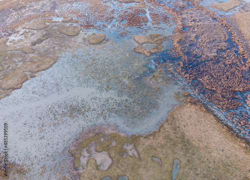 Abstract aerial drone view with wet green field