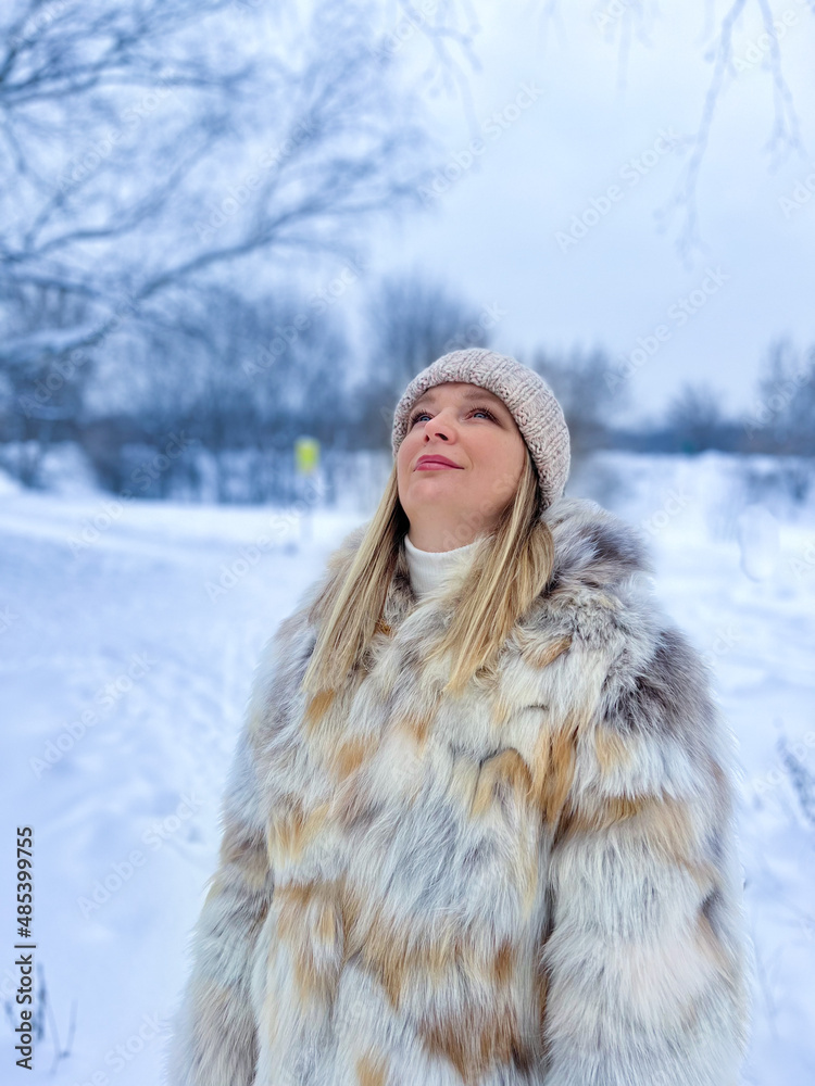 The girl inhales the frosty air in the park.