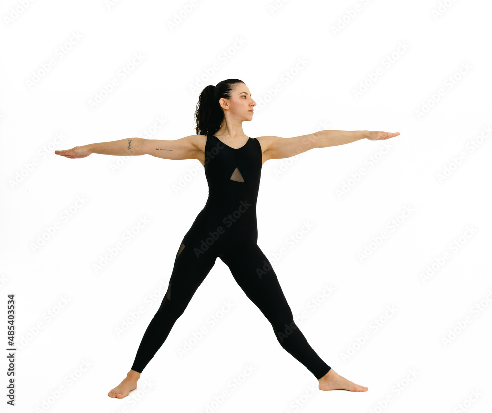 Woman doing yoga asana in white background. Black outfit. Ashtanga, Vinyasa, Hatha Woman doing yoga asana in white background. Black outfit. Ashtanga, Vinyasa, Hatha