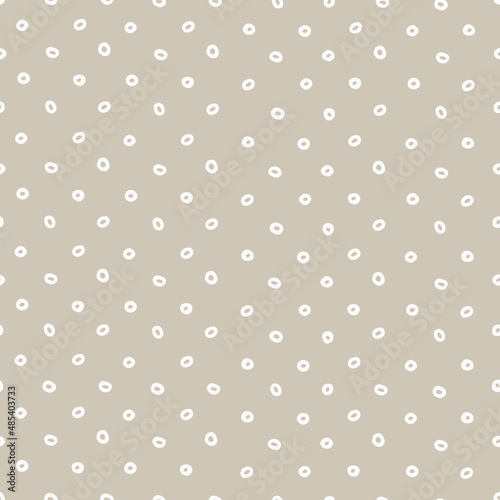 Seamless geometric pattern with hand drawn uneven white rings on beige background for surface design, craft, apparel and other design projects