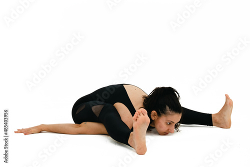 Woman doing yoga asana in white background. Black outfit. Ashtanga, Vinyasa, Hatha