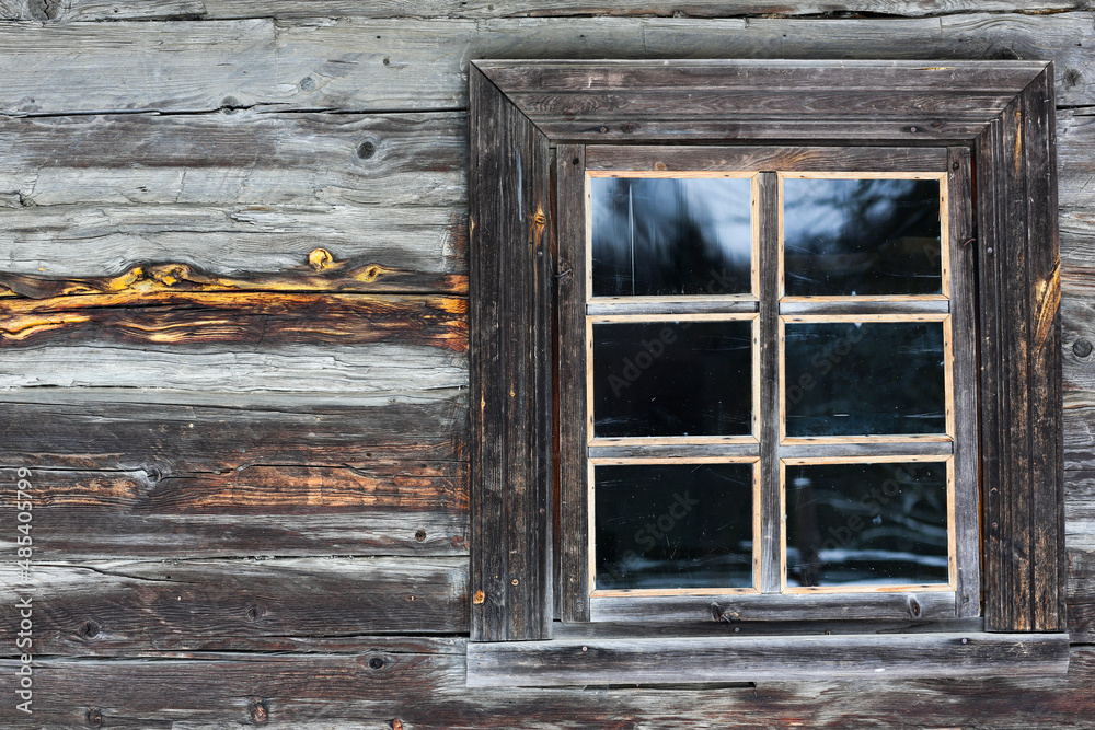 Rustic wooden house made of round logs. Abandoned villages and houses. Ancient window design. Wooden window frame. Snow covered village. Age-old buildings. Professional photography. Rustic wooden house made of round logs. Abandoned villages and houses. Ancient window design. Wooden window frame. Snow covered village. Age-old buildings. Professional photography.