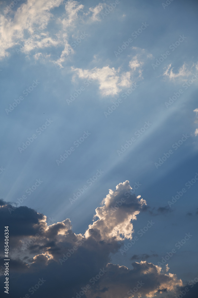 Sun rays penetrating through the clouds. Sunbeams and clouds.