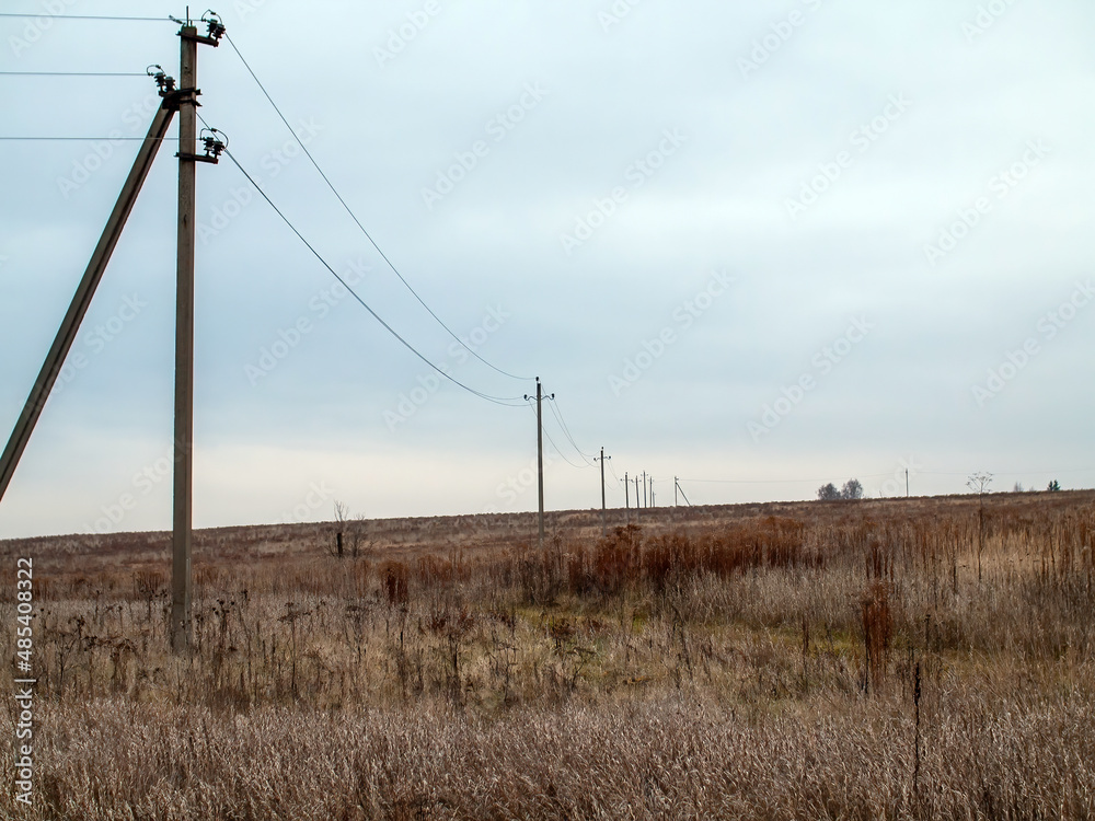 poles with electrical wires stand in the field poles with electrical wires stand in the field