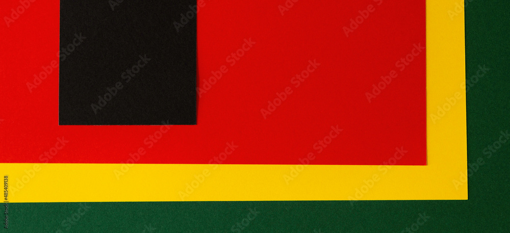 Black History Month color background. African American history month celebration. Abstract red, yellow, green color flag on black paper background