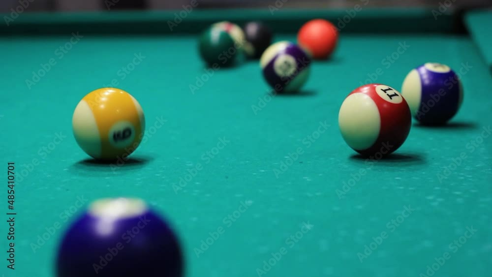 Male hand hits the ball in billiards american woman close up Male hand hits the ball in billiards american woman close up